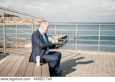 Confident Middle Age Businessman Working Remotely Online, Typing On A Laptop Keyboard While Sitting 