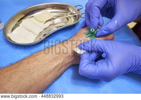 Preparation For Vein Catheterization Close Up. Intravenous Catheter In The Hands Of A Doctor