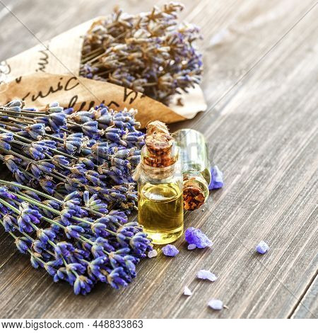 Lavender's Spa Products With Dried Lavender Flowers On A Wooden Table. Flat Lay Bath Salt And Massag
