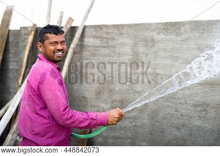 Happy Construction Labour Curing Brick Cement Wall By Using Water To Avoid Cracks And Increase The S