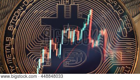 Cryptocurrency Bitcoin Gold Coin And Defocused Chart Background.