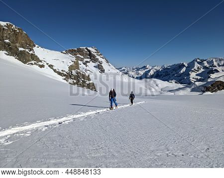 Ski Touring In Deep Snow On The Glacier. Mountaineering On The Clariden In The Swiss Mountains From 