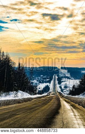 Landscape with the image of winter road at sunset in Tarusa, Russia