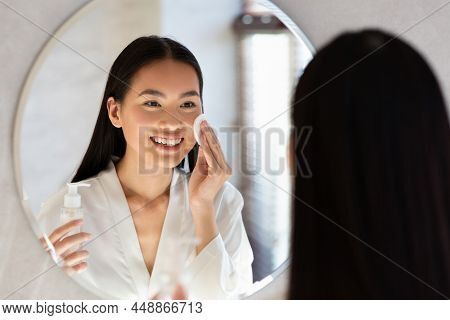 Attractive Asian Lady Using Cleansing Milk, Removing Makeup