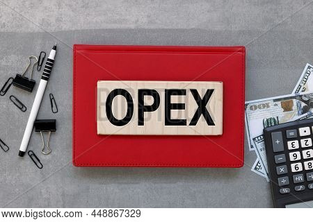 Opex Text On Text On Wooden Blocks On Red Background