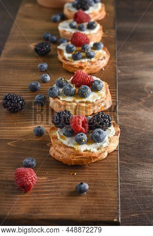 Sweet Berry Crostini Sandwiches With Cream Cheese Ricotta, Blueberries And Honey On The Whole Grain 