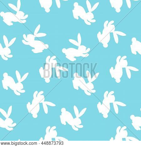 Seamless Pattern With White Silhouette Easter Rabbits On Blue Background. Design For Card, Postcard,