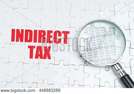 Business Concept. There Is A Magnifying Glass On The Puzzles, Next To It Is Written - Indirect Tax