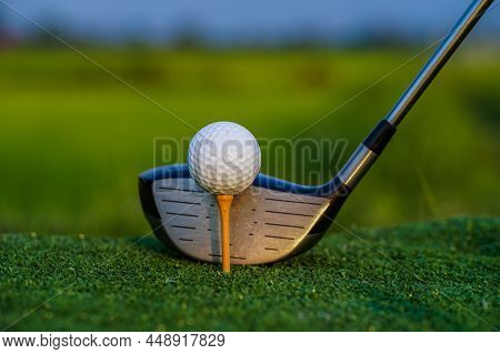 Golf Club And Ball On Green Grass Ready To Be Struck On Golf Course Background, Lens Flare On Sun Se