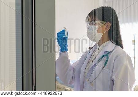 Young Female Doctor Holding Atk Kit In Hospital, Covid19 And Pandemic Concept