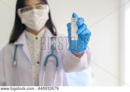 Young Female Doctor Holding Atk Kit In Hospital, Covid19 And Pandemic Concept