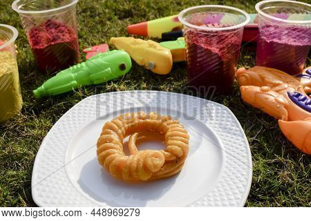 Holi Theme Greeting Wishes Photo Image With Indian Sweet Dessert Imarti With Waterguns, Pichkari And