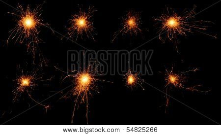 Set Of Burning Sparklers On Black Background.