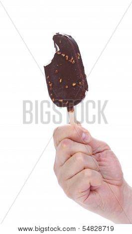 Bitten chocolate-coated ice cream on stick.