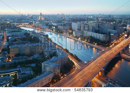 Moskva River and Building on Kotelnicheskaya Embankment at summer night in Moscow, Russia. Long exposure. View through window.