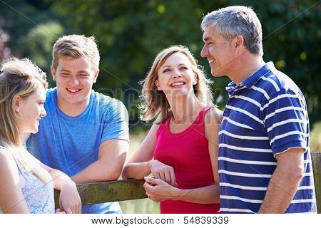 Family With Teenage Children Walking In Countryside
