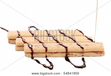 Stream chocolate on stics of biscuit.