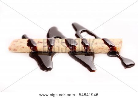 Stream chocolate on stics of biscuit.