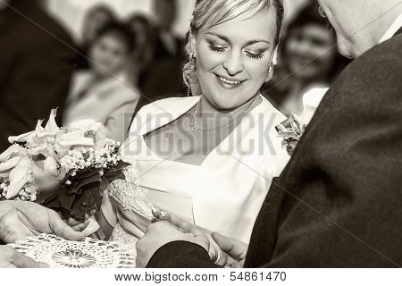 Groom Happy Putting Ring On Smiling Pretty Woman Bride's Finger