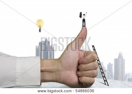 Businessman Standing On Top Of Thumb, Another In Lamp Balloon