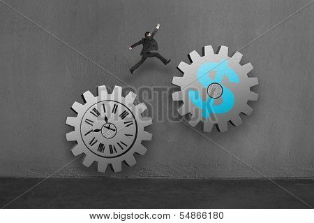 Businessman Jumping On 2 Large Concret Gear