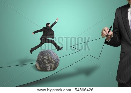 Businessman Drawing Road With Arrow, Another Jumping Over Rock