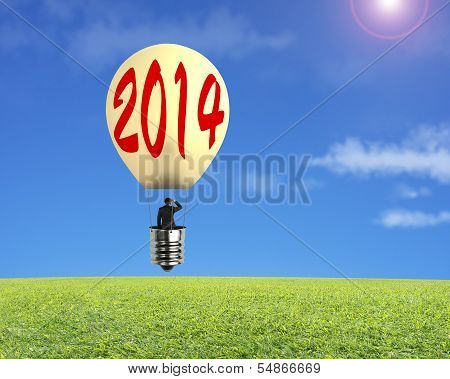 Man Taking Lamp Balloon Floating Over Meadow And Looking At