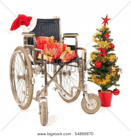 Empty wheelchair with Christmas gifts and tree isolated over white background
