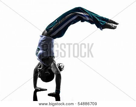 one caucasian woman capoeira dancer dancing in silhouette studio isolated on white background