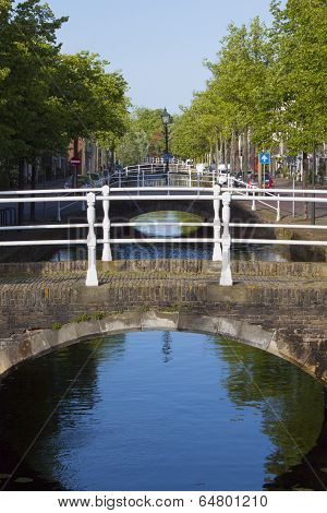 Bridge Over Canal With Reflection And Trees