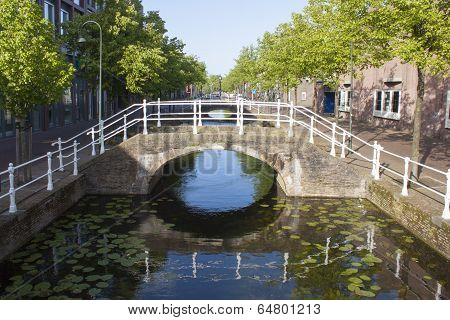 Bridge Over Canal With Reflection And Trees