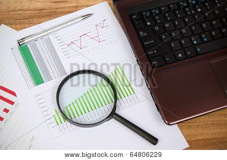 Magnifier On Business Wooden Background