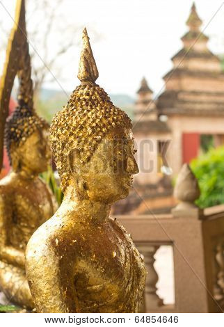 The Buddha statue with gold leaf.