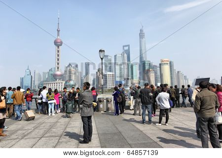 SHANGHAI, CHINA - APRIL 7, 2014: People on The Bund waterfront in Shanghai