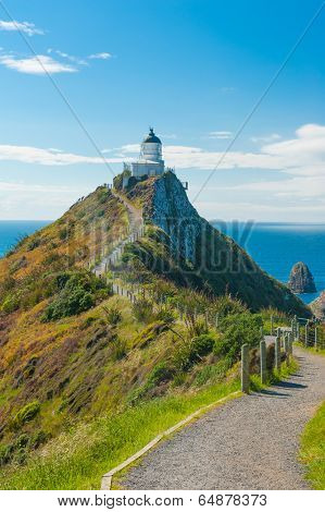 Lighthouse on Nugget Point. It is located in the Catlins area on the Southern Coast of New Zealand, Otago region. The Lighthouse is surrounded by small rock islands, nuggets