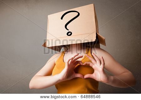 Young lady standing and gesturing with a cardboard box on her head with question mark