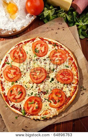 Pizza Margherita made with Tomatoes, Gauda Cheese and Mozzarella