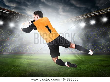 soccer or football goalkeeper is catching ball on stadium