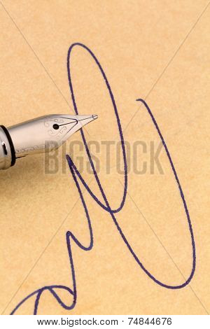 a signature and a fountain pen on yellow paper. symbol photo for contract testament and graphology
