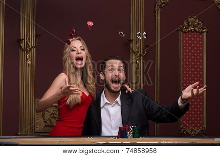 Handsome man and beautiful woman in casino