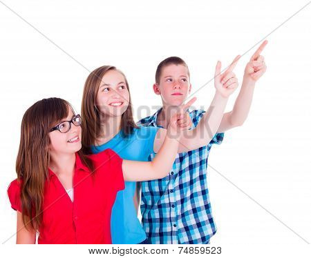 Teenagers Pointing And Looking Up To Copy Space