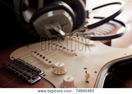 Guitar recording scene. An electric guitar, and a professional grade headphones. 