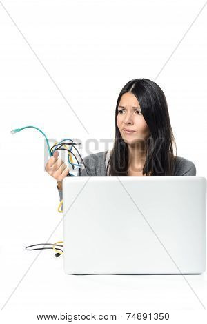 Woman Holding Cables In Her  Hand While Using Laptop