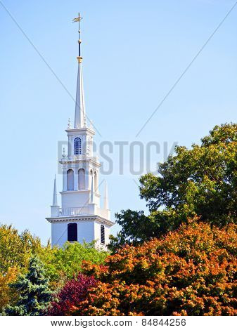 White new england style colonial church spire in fall