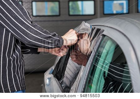 Applying Tinting Foil On A Car Window