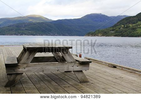Wooden table on the lake shore