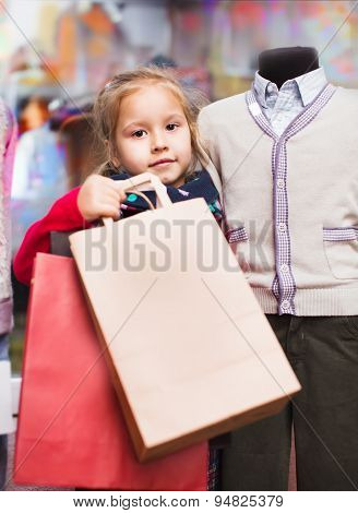 portrait of cute little girl with shopping bags