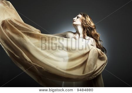 Portrait Of The Young Woman Against A Flying Fabric