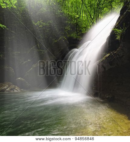 Waterfall Illuminated By Sunshine
