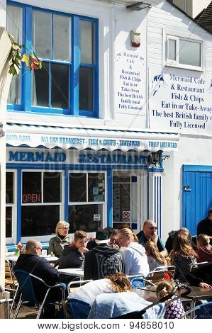 People lunch outside of the fish & chips restaurant